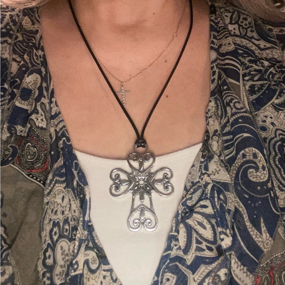 Silver Cross necklace with leather cord and silver clasp.